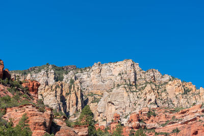 Scenic view of rocky mountains against clear blue sky