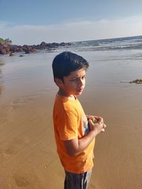 Boy standing on beach