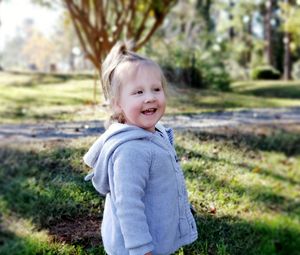 Cute smiling girl standing in park