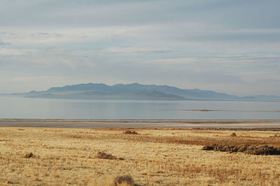 Scenic view of mountains against cloudy sky