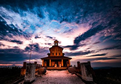 Historic building against sky at sunset