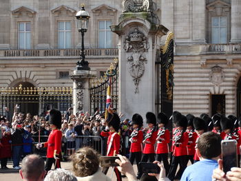 Men in uniforms marching on street