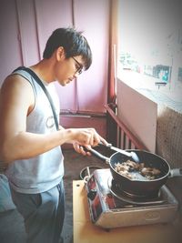 Side view of man preparing food at home