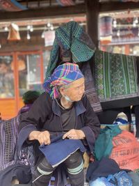 Rear view of woman sitting in store