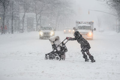 People standing on snow covered landscape