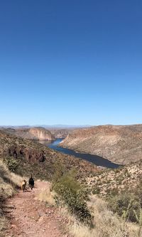 Scenic view of desert against clear blue sky