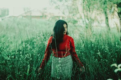 Young woman standing on field