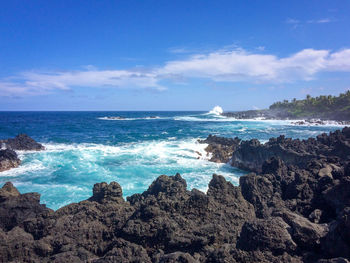 Scenic view of rough black coastline at waianapanapa state park, maui, hawaii against sky