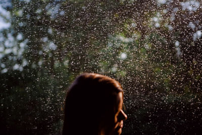 Portrait of woman with umbrella in rain