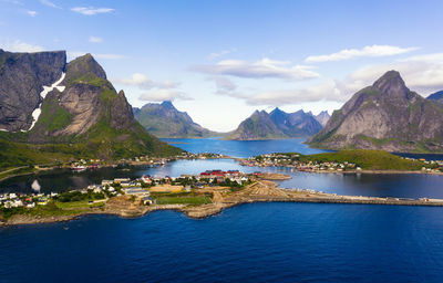 Scenic view of sea and mountains against sky