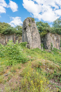 View of rocks on field against sky