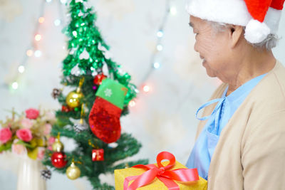 Midsection of man with christmas tree