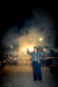 Full length portrait of young man standing against sky