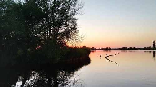 Scenic view of lake against sky during sunset