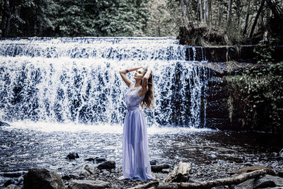 Woman looking at waterfall