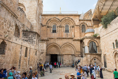 People outside historic building