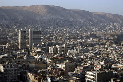 Aerial view of buildings against mountain range