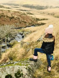 Side view of girl looking across wilderness 