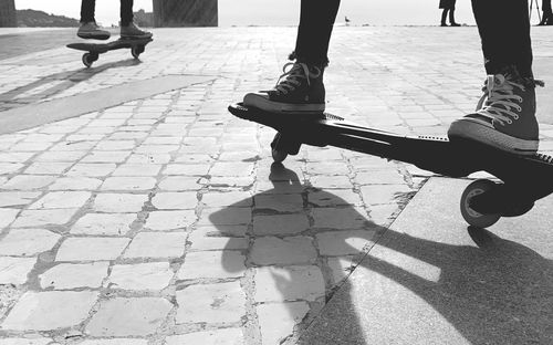 Low section of person skateboarding on street