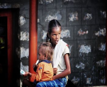 Siblings standing outdoors