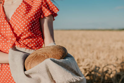 Midsection of woman standing in field