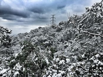 Scenic view of snow covered mountain against cloudy sky