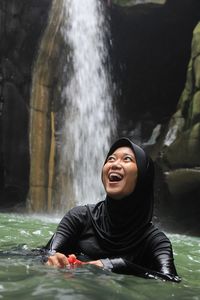 Portrait of smiling young woman in water