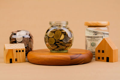 Close-up of coins in jar on table