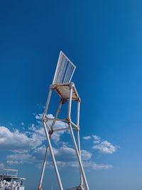 Low angle view of windmill against blue sky