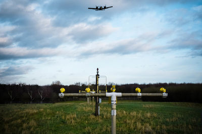 Low angle view of airplane flying on field against sky