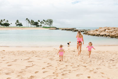 Mother with children playing on beach