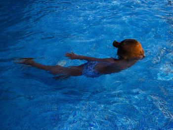 High angle view of girl swimming in pool