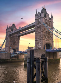 View of bridge over river at sunset