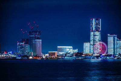 Illuminated city at waterfront