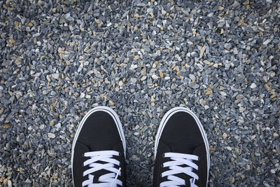 Low section of person standing on road