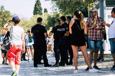 Rear view of people walking on street