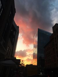 Low angle view of buildings against sky at sunset