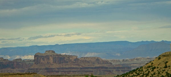 Scenic view of mountains against cloudy sky