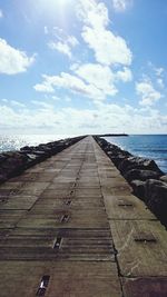 Pier over sea against sky