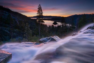 Scenic view of river against sky during sunset