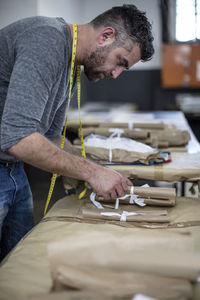 Tailor at work in workshop