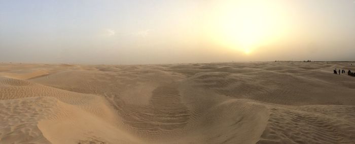 Scenic view of desert against sky during sunset