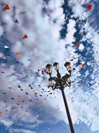 Low angle view of flags hanging against sky