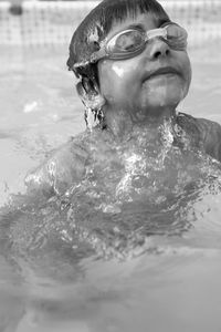 Shirtless boy swimming in pool