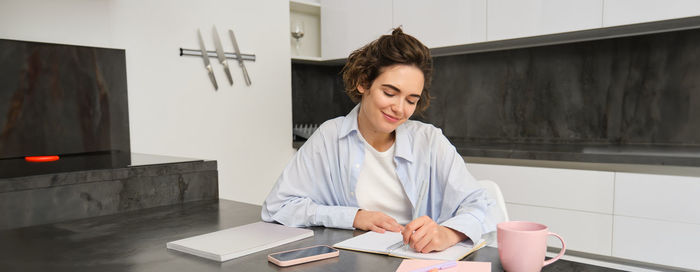 Portrait of female doctor working at table