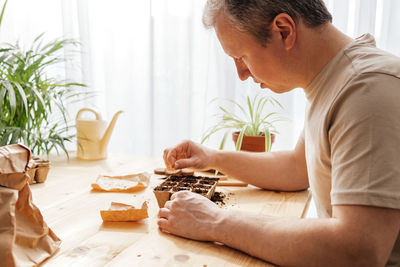 Side view of boy playing with cookies at home