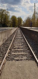 Surface level of railroad tracks against sky