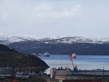 Scenic view of sea by city against sky