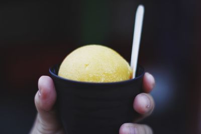 Close-up of cropped hand holding ice cream