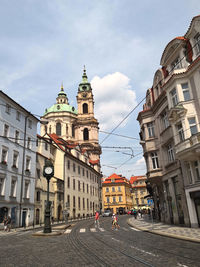 Street amidst buildings in town against sky